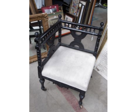 An Aesthetic Movement ebonised corner chair, in the style of Christopher Dresser, circa 1880, Moorish style with opposing dem