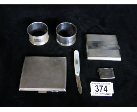 Silver, including engine turned cigarette case, compact and two napkin rings and a novelty envelope stamp box