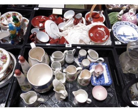 A Noritake tea service, decorated with flowers on a deep rust ground, comprising teapot, teacups and saucers, milk jug, sugar