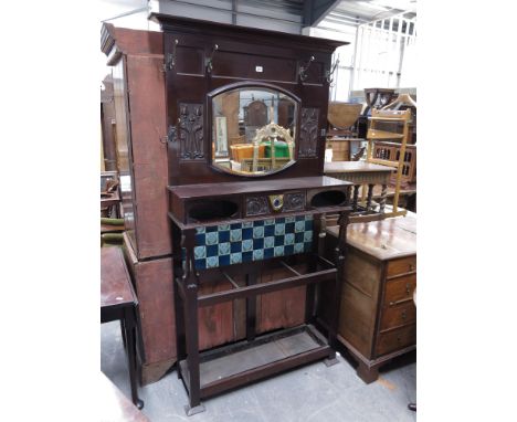 A mahogany Art Nouveau hallstand, the upper section with bevelled mirror flanked by stylised floral devices, single draw and 