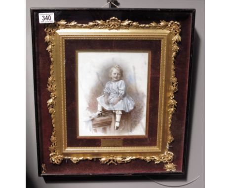 A late Victorian photographic portrait of a child on opaque glass, signed N.May &amp; Co, Cheltenham 1892, titled on gilt pla