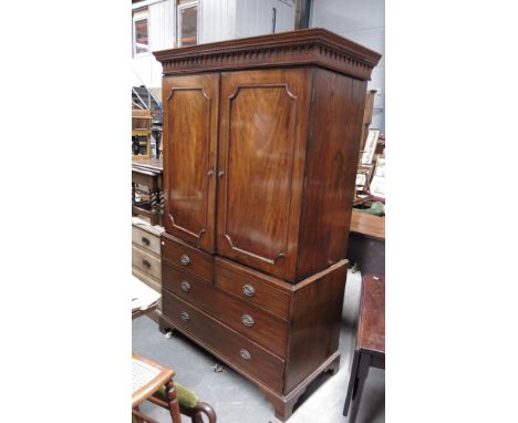 A George III flame mahogany linen press, circa 1800, plain cornice, Greek key frieze, double panel doors to the upper section