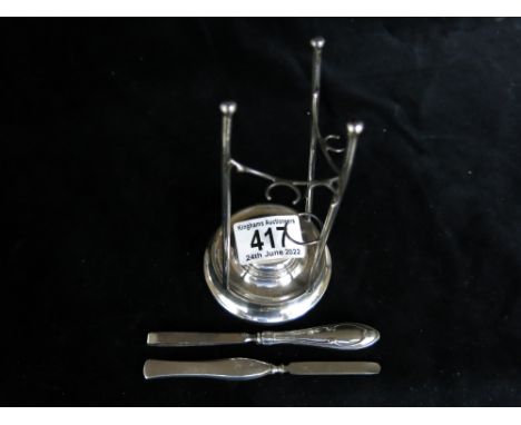 A silver manicure stand with tools
