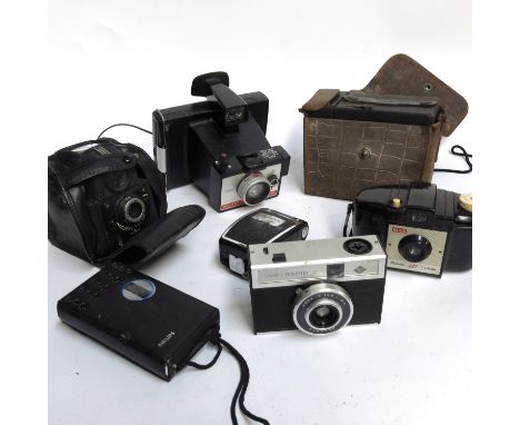 A collection of camera equipment including Polaroid Color Pack 80 etc