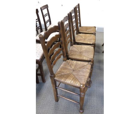 A set of four traditional country ladder back dining chairs, with rush seats, baluster stretchers, and pad feet (4)