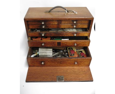 A 20th century oak engineers toolbox, front panel with four short over three long drawers, label mark GBF, 20cm wide, 44cm lo
