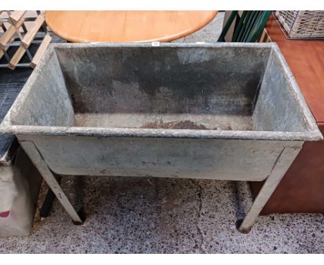 A RAISED GALVANISED TROUGH, 28" LONG X 20" WIDE X 30" TALL