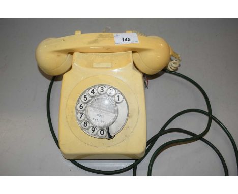 A vintage cream plastic telephone