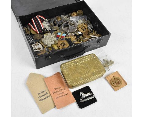 A collection of WWI &amp; WWII related items including Christmas 1914 chocolate tin, various cap badges including Royal Milit
