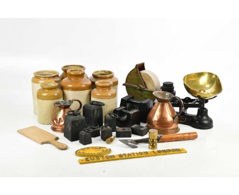 An assortment of metalware including copper haystack jugs, balance scales and assorted weights, two cast iron signs including