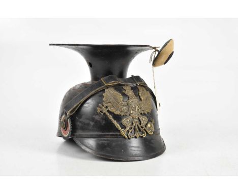 A World War I German Uhlan helmet, Ersatz regiment, with cockade and side decoration, brass front plaque.