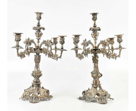 A pair of large and impressive Victorian style five branch candelabra, each with cast decoration of grapes, vine leaves and s