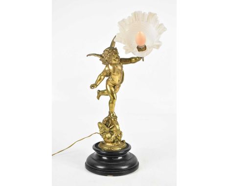 A late 19th century gilt spelter figural table lamp modelled as a cherub supporting the milk glass shade, bears plaque 'L'Amo