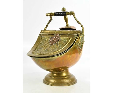 A 19th century brass and copper helmet shaped coal bucket, with repoussé decoration and turned ebonised handle, and shovel, h