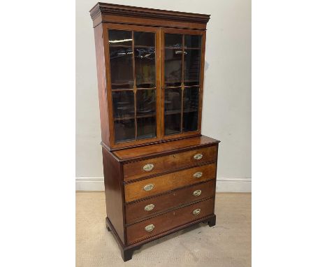 A Georgian inlaid mahogany secretaire bookcase, the upper section with moulded cornice above two glazed doors enclosing three