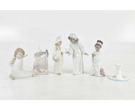 LLADRÓ; a group of four figures comprising girl praying, young man with a chamberstick, seated cherub and hooded figure, a Ll