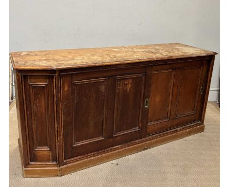 A Victorian pine side cabinet with sliding doors enclosing fixed shelf, plinth base, approx width 190cm, depth 58cm, height 9
