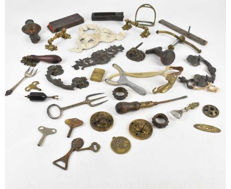 A collection of Victorian and later door/cabinet mounts and assorted collectors' items including corkscrew, stirrups, stamps,