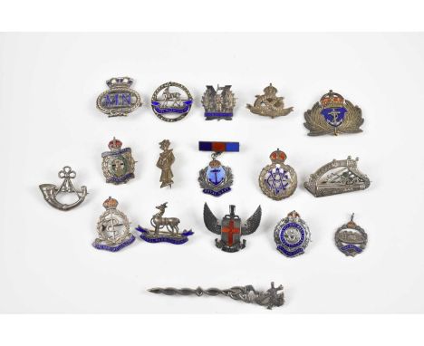 A collection of seventeen silver and white metal military and Naval badges and brooches including Royal Warwickshire Reg, Roy