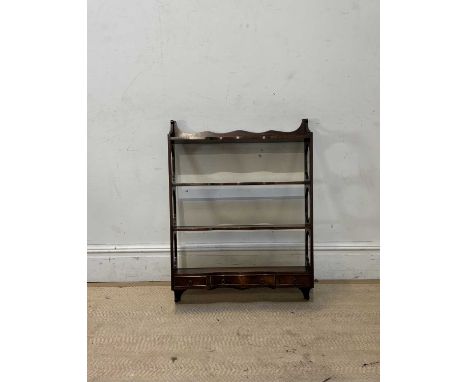 A reproduction mahogany serpentine fronted wall shelf with three base drawers, height 90cm, width 68cm.