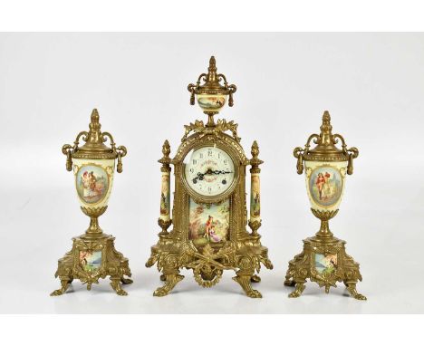 A reproduction French Regency style brass mantel clock, with transfer decoration, and two matching garnitures, height of cloc