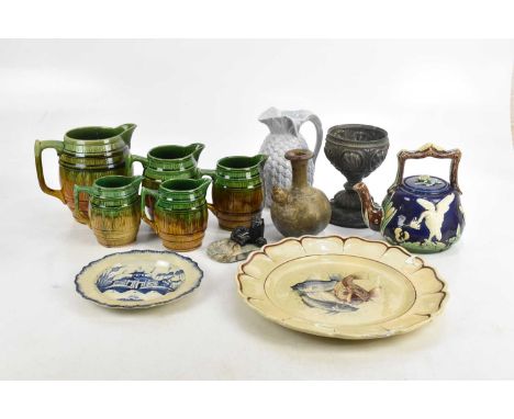 A Victorian majolica teapot, relief decorated with birds and floral detail, a graduated set of five majolica glazed barrel ju