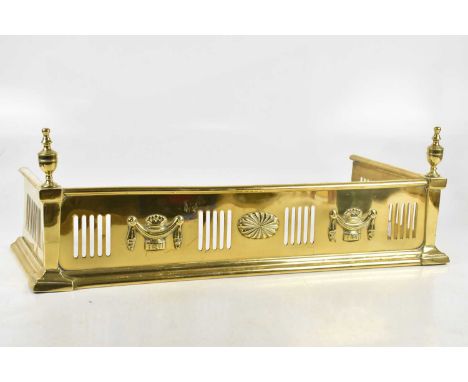 A Regency effect miniature brass fender with applied urns, width 65cm.