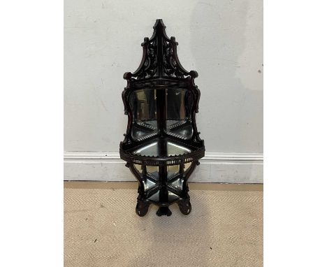 A 19th century carved mahogany corner shelf with mirrored panels, height 94cm.