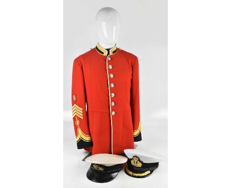 A British army dress tunic fitted on mannequin, and two Royal Navy peaked visor caps. 