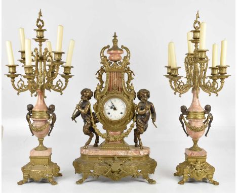 A large and impressive gilt metal and rouge marble three piece clock garniture comprising the lyre shaped clock with urn fini