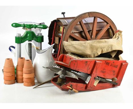 A collection of vintage collectors' items comprising a cart wheel, a painted metal press, enamel milk pourer and jug, a dieca