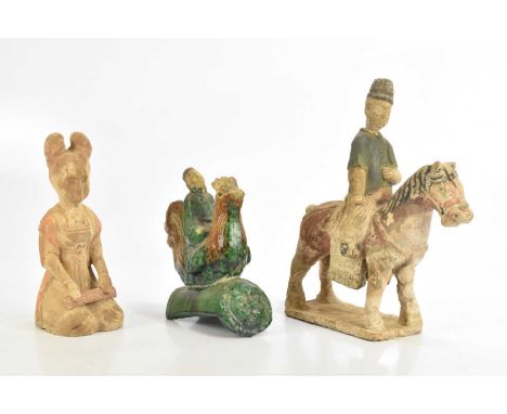 A Chinese Tang style model of a horse and rider, the rider with detachable head, height 29cm, a Chinese roof tile modelled as