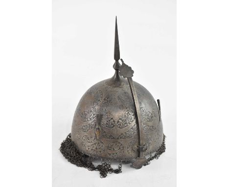 A Persian Kula Khud iron helmet, with spike finial, chain mail mantles and adjustable nose guard, decorated with floral patte