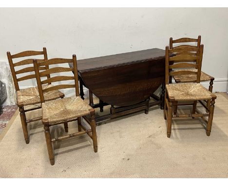 A 19th century oak drop-leaf gateleg dining table, with single end drawer, length approx 120cm, and four ladder back rush sea