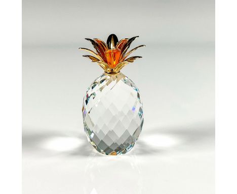 Stunning faceted crystal figure of a pineapple with bright gold colored metal leaves on the top. Swarovski etched stamp. This