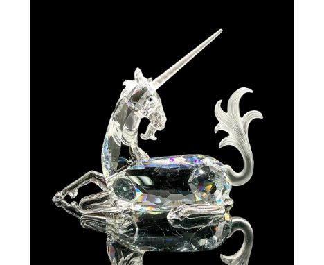Brilliant cut crystal figure of a majestic unicorn lying down with frosted horn, tail and mane. Swarovski etched mark. The Un
