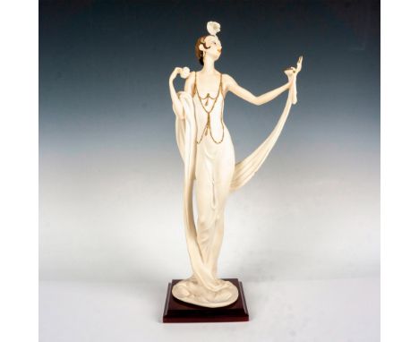 A beautiful porcelain figure of a slender 1920s woman clutching her compact powder atop of a glossy wooden base. Florence Giu