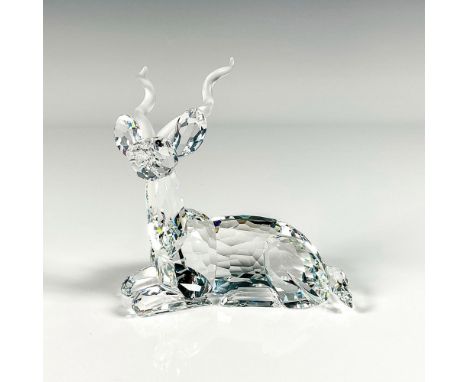 Striking cut crystal figure of a kudu, a type of antelope, lying down resting, with frosted crystal horns. Part of the Africa