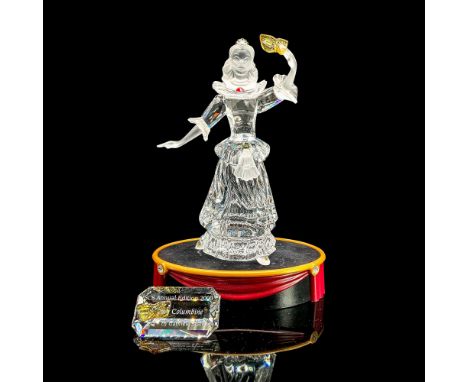Brilliant clear crystal with arm raised holding mask. Satin head and arms. Swarovski Crystal Society figure. Part of the Masq