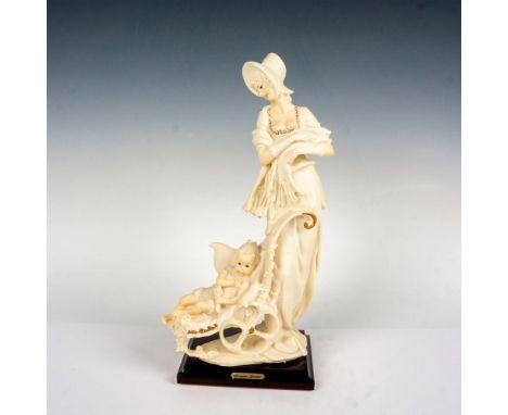 A charming figure of a mother on a stroll with her child atop of a glossy wooden base. Giuseppe Armani plaque on the front of