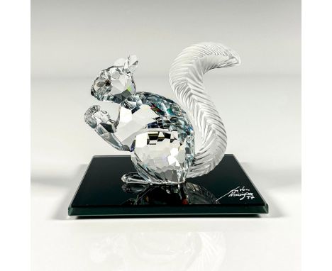 Clear faceted crystal figure of a squirrel holding a crystal. Includes artist signed black glass base, 3"W x 3"L. This item h