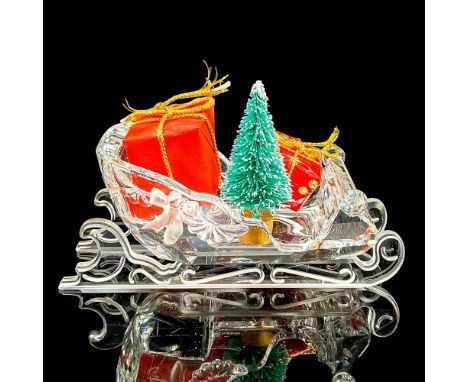 Clear crystal figure of a sleigh with two presents and a tree inside. Swarovski mark. This item has its original box: 5.75""H