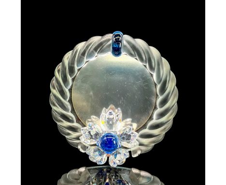 Satin crystal round frame with faceted clear crystal flower at bottom, blue pistil. Swarovski mark. This item has its origina