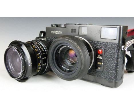 Minolta CLE 35mm camera, serial number 1007103 with M-Rokkor 40mm 1:2 lens, together with a similar 28mm 1:2.8 lens and boxes