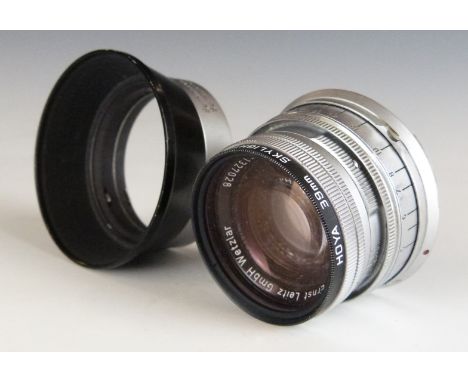 Leitz Summicron f=5cm 1:2 camera lens, serial number 1327028, with Leica M mount, together with caps and hood