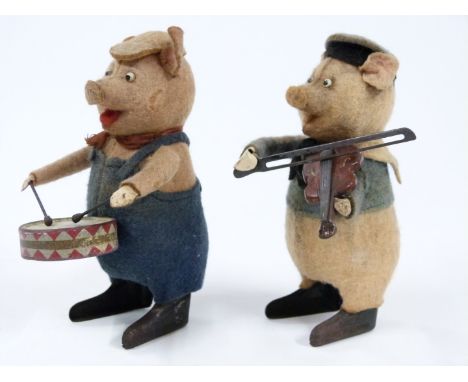 Two Schuco felt clockwork model Disney's Three Little Pigs each playing musical instruments, one playing the violin the other