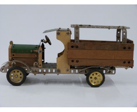 Meccano or Butcher &amp; Sons Primus model of a lorry, made using green, unpainted and wooden parts, 37cm long.&nbsp;