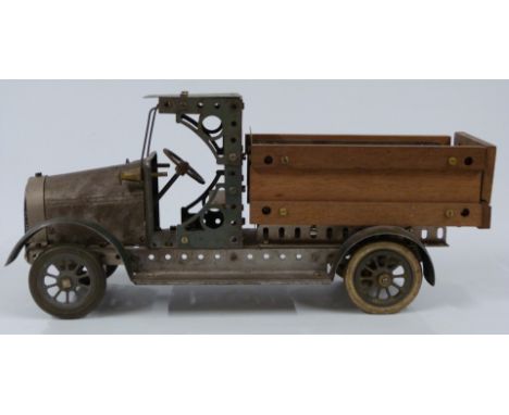 Meccano or Butcher &amp; Sons Primus model of a lorry, made using green, unpainted and wooden parts, 37cm long.&nbsp;