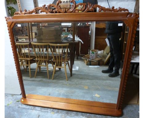 A mahogany overmantel mirror with bevelled glass, integral shelf and removable ornate finial, 138x147cm