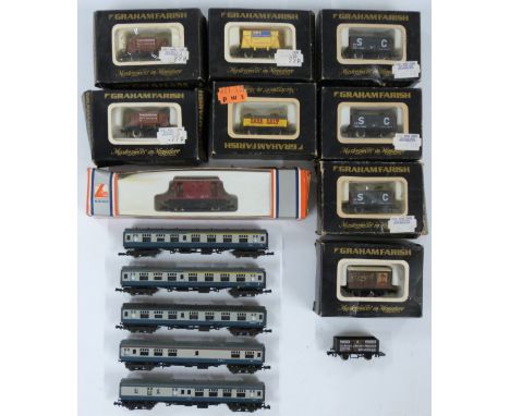 Graham Farish N gauge model railway rolling stock comprising five BR blue coaches, nine goods wagons and a Lima brake van, so